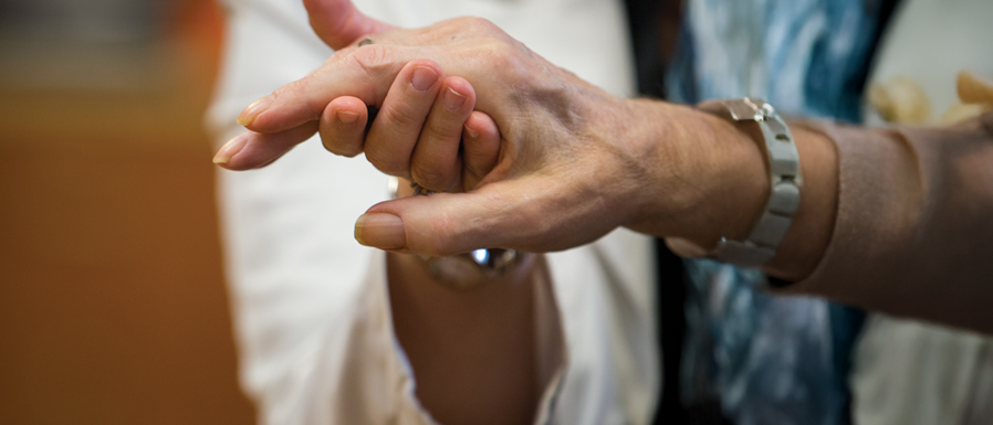 physician hand holding a patient's hand