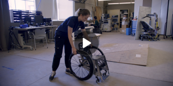A research engineer testing a custom wheelchair that was inspired by the Japanese art form of Origami