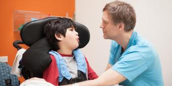 physician examining a young child with disabilities