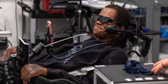 man uses a brain-computer interface to navigate tasks