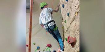 young man climbing a rock wall